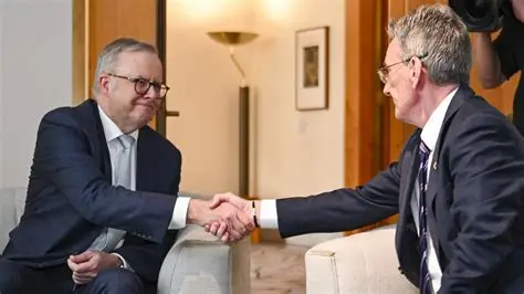 Wayne Holdsworth shaking hands during a meeting at Parliament House